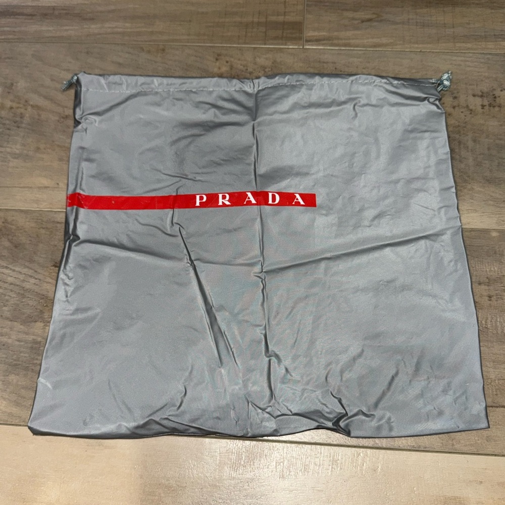 Prada Silver Dust Bag with Red Logo